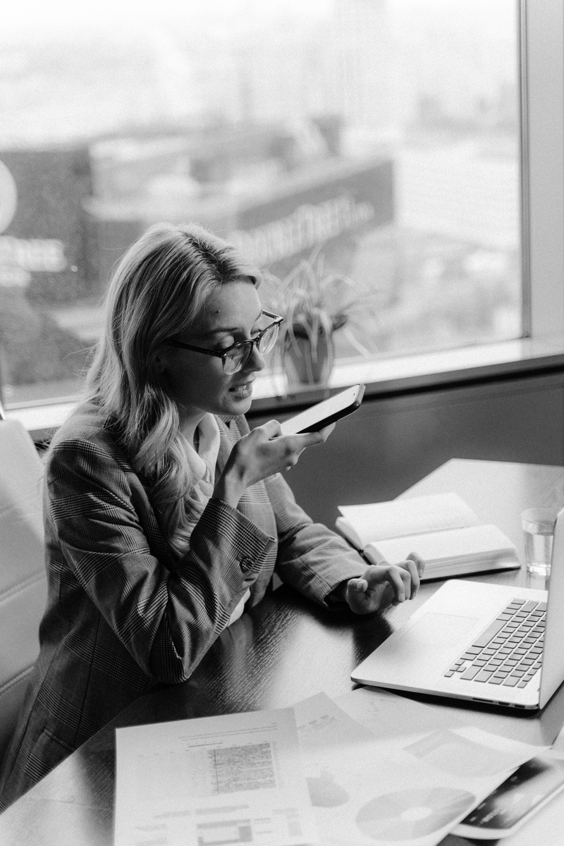 Woman in Black Leather Jacket Sitting at the Table